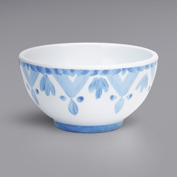 A white melamine bowl with a blue and white painted surface.