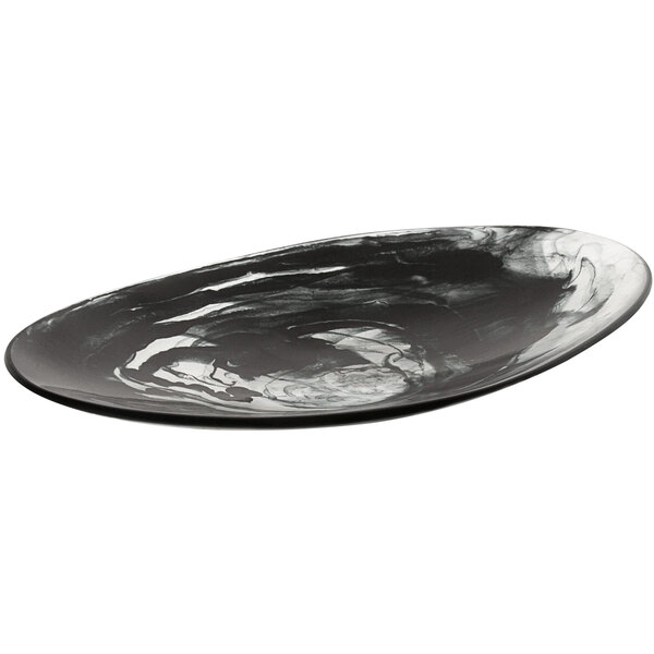 A black and white oval Bon Chef shallow resin bowl on a table.