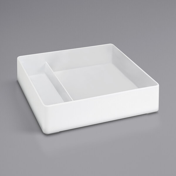 A white square rectangular object with two compartments.
