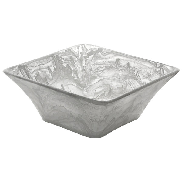 A white square bowl with a swirl pattern.