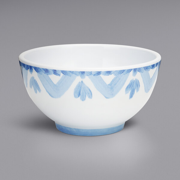 A white melamine bowl with blue and white designs.