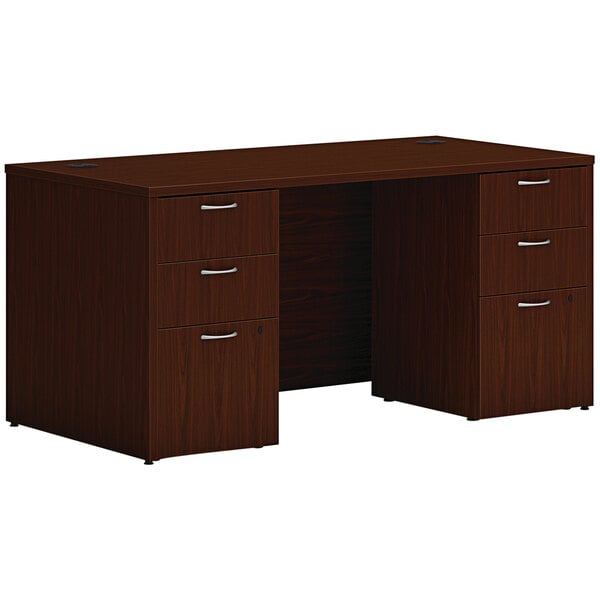 A traditional mahogany Hon desk with 2 storage pedestals.