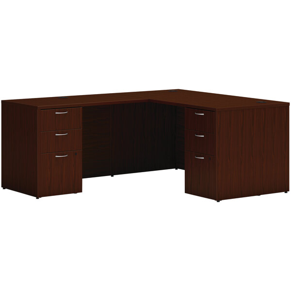 A brown Hon traditional mahogany laminate L-station desk with 2 storage pedestals.
