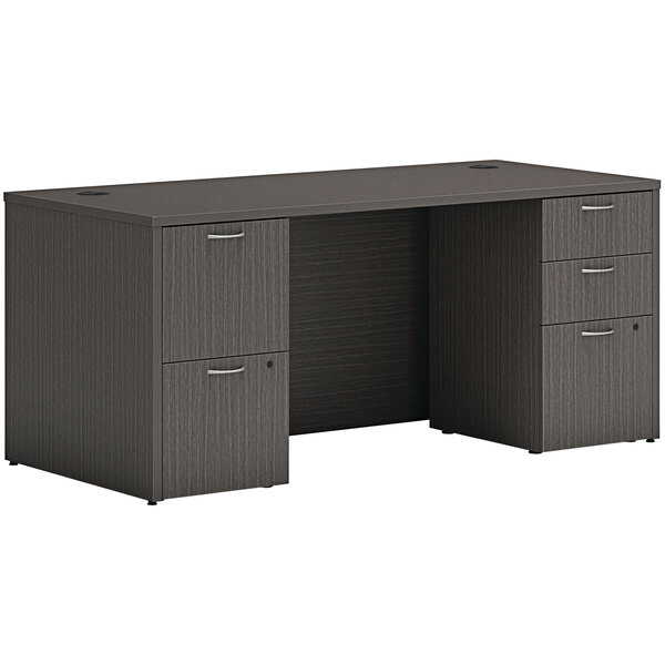A black Hon slate teak laminate desk with drawers.