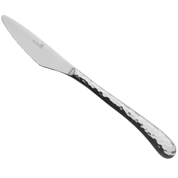 A silver knife with a textured curved handle.