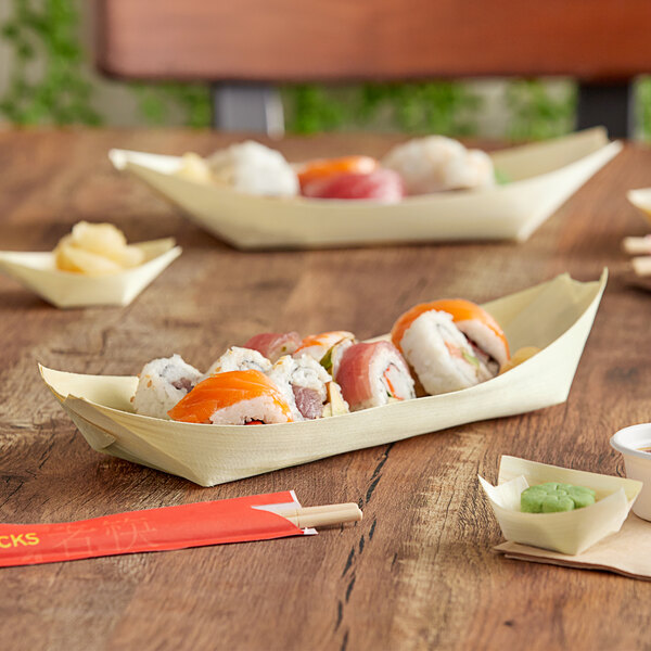 A wooden table with EcoChoice wooden food boats filled with sushi on it.