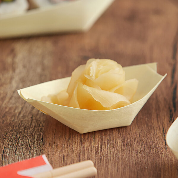 An EcoChoice wooden paper boat filled with food.