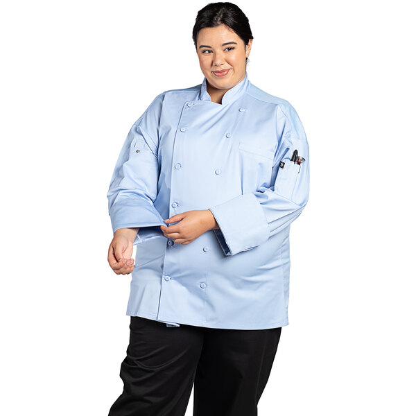 A woman wearing a Uncommon Chef sky blue long sleeve chef coat with a mesh back.