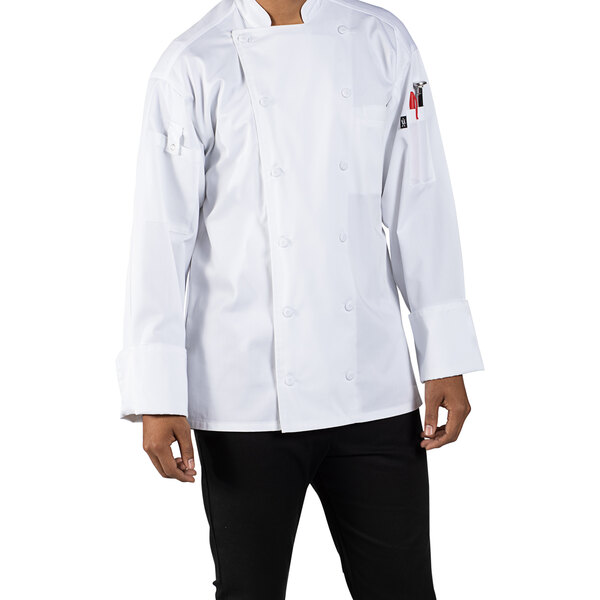 A man wearing a white Uncommon Chef Vigor Pro Vent long sleeve chef coat with mesh back.
