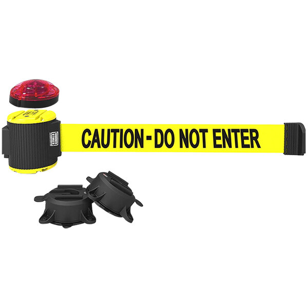 A yellow Banner Stakes wall mount barrier with a "Caution - Do Not Enter" sign and a red light.