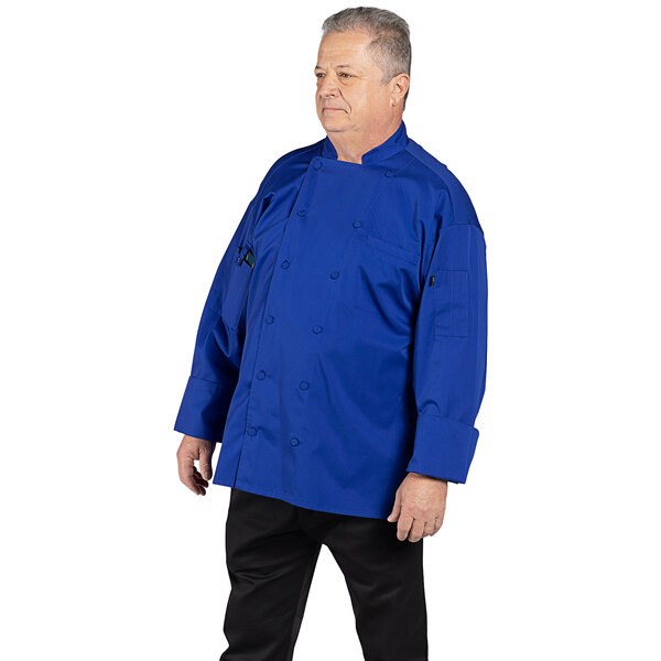 A man wearing a deep royal blue Uncommon Chef Vigor Pro Vent chef coat.