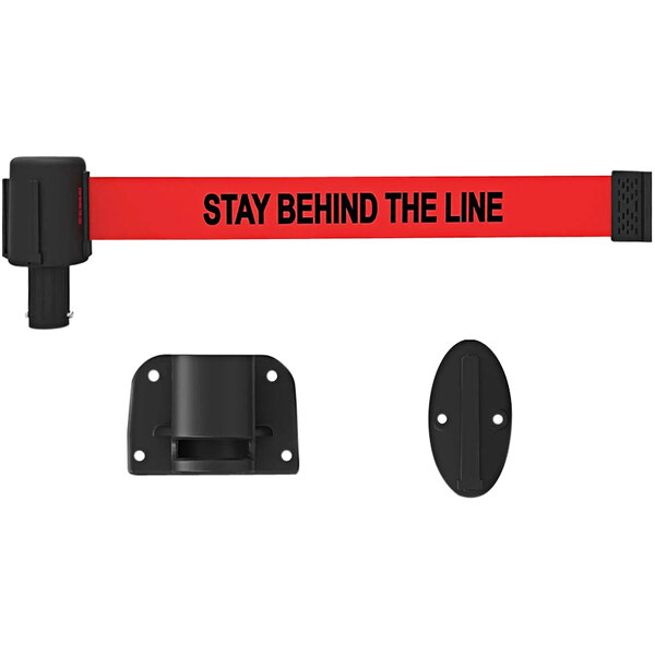 A white sign with a black and red oval plastic barrier and black text reading "Stay Behind the Line"