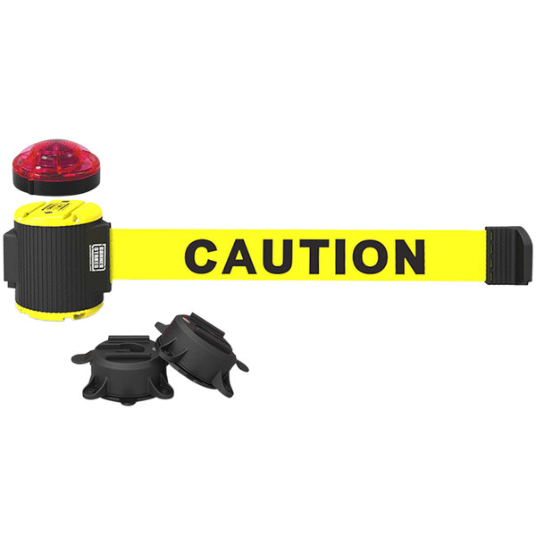 A yellow Banner Stakes "Caution" tape with a black wall mount and light kit.
