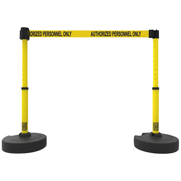 A pair of yellow and black Banner Stakes Plus barriers with "Authorized Personnel Only" tape.