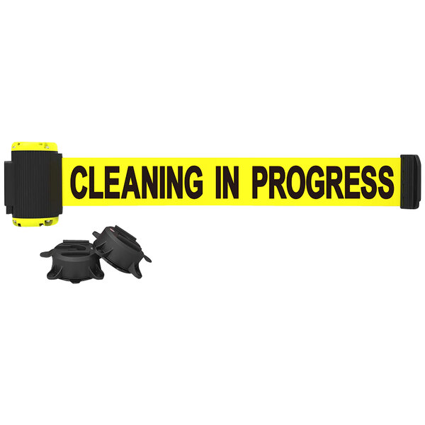 A yellow Banner Stakes wall mount tape with black text reading "Cleaning in Progress" and a black circular wall mount.
