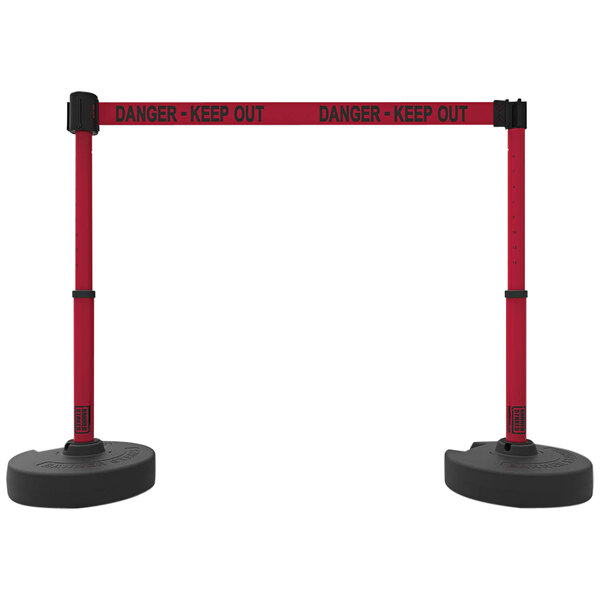 A pair of red and black Banner Stakes retractable barriers with "Danger - Keep Out" written on them.