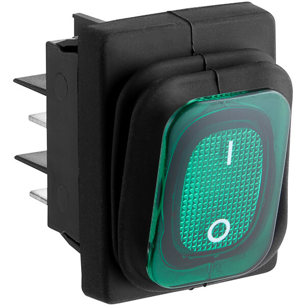 A green push button switch with white text on a black surface.