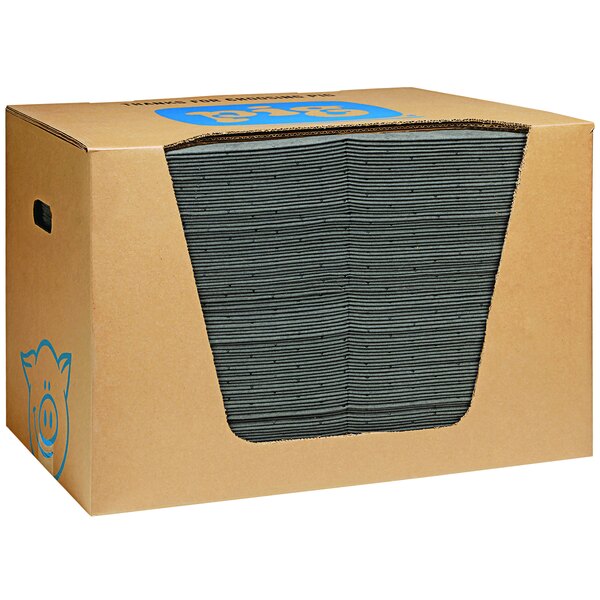 A large cardboard box with a large stack of black New Pig absorbent pads.