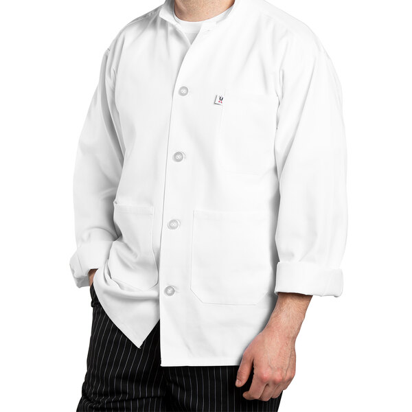 A man wearing a white Uncommon Chef long sleeve chef coat.