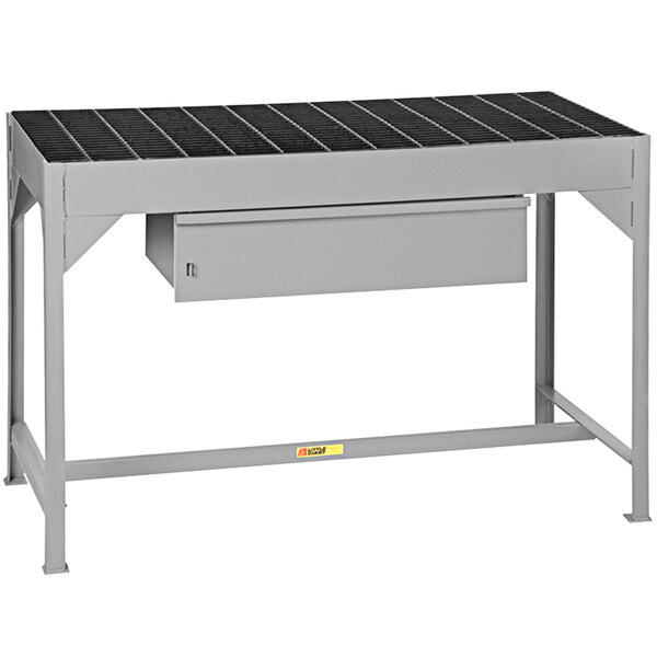 A grey metal Little Giant welding table with a drawer.