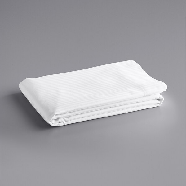 A folded white Oxford Superblend tone on tone stripe flat sheet on a gray surface.