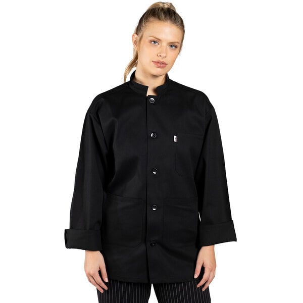 A woman wearing a black Uncommon Chef long sleeve chef coat.