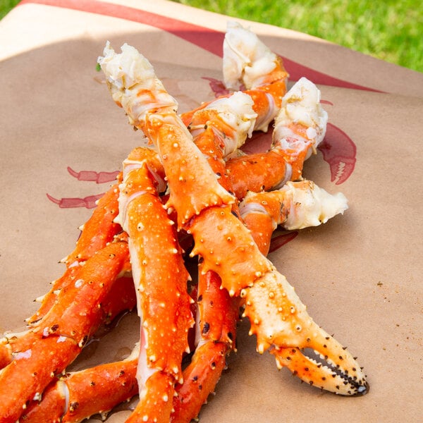A pile of Chesapeake King Crab legs on a brown paper bag.