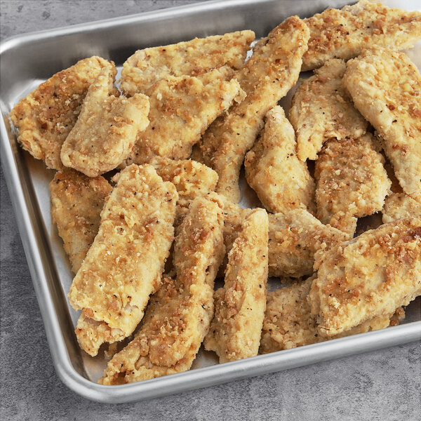 A tray of Daring Foods breaded vegan chicken strips fresh out of the oven.