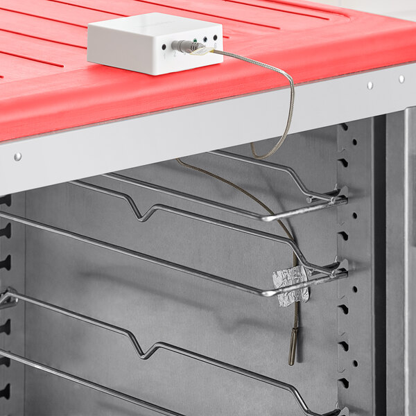 A white box with a wire for a VersaTile high-temp air temperature probe on a red surface.