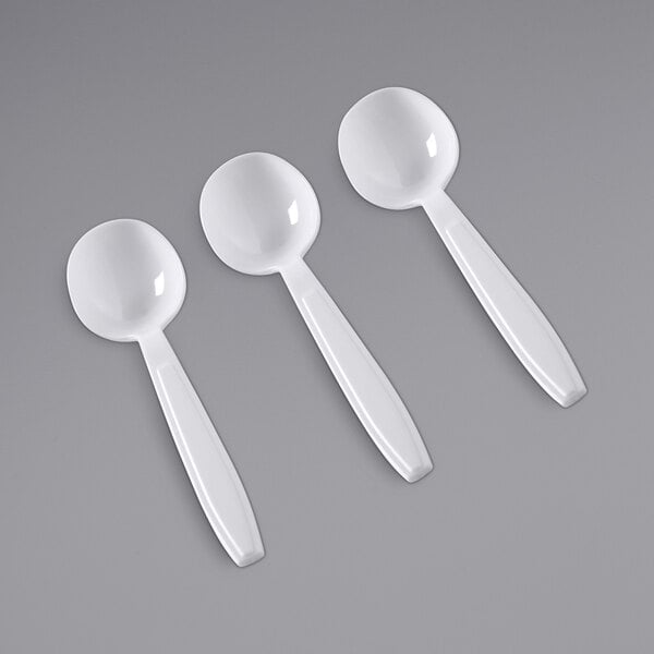 A close-up of a white Fineline Flairware plastic soup spoon.