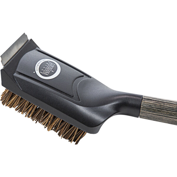 A black and silver Louisiana Grills cleaning brush with a handle and brown bristles.