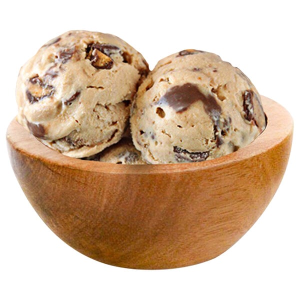 A wooden bowl with three scoops of G.S. Gelato REESE'S and Cream gelato.