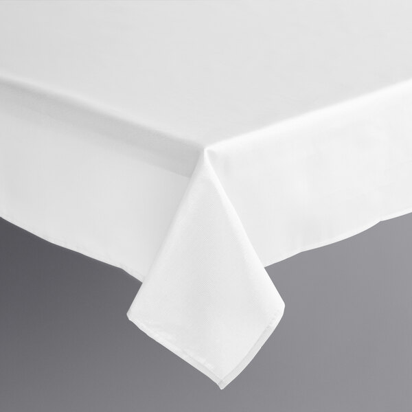 A white Amscan rectangular tablecloth with a silver hemmed edge on a table.