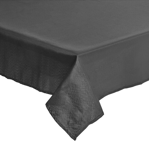 A black Amscan rectangular cloth table cover with a folded edge on a table.
