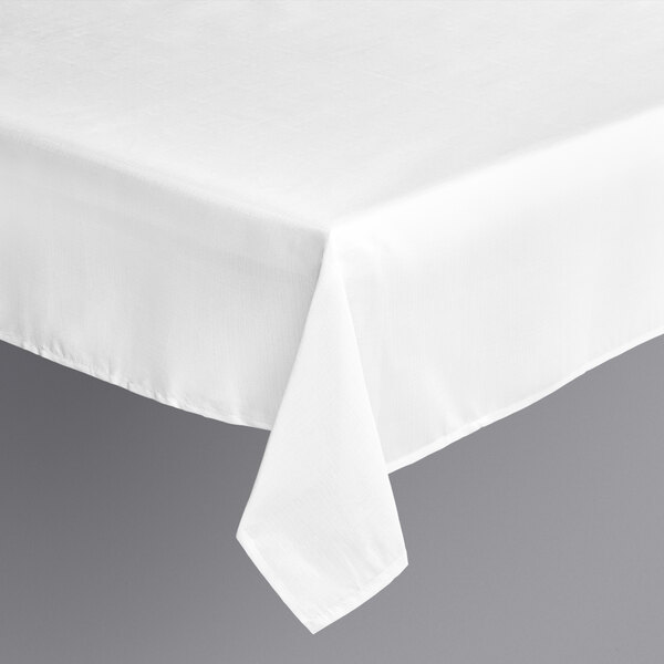 A white Amscan rectangular polyester table cover on a table.