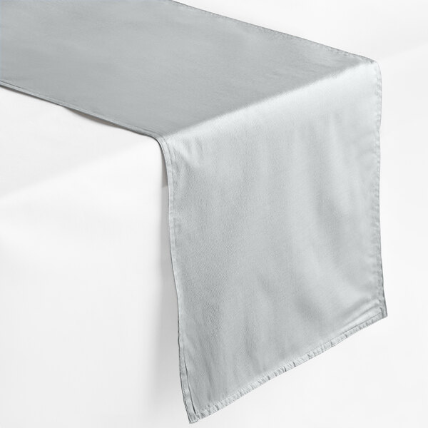 A silver rectangular premium hemmed cloth table runner on a white table.