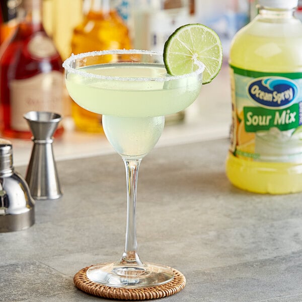 A glass of Ocean Spray Sour Mix with a lime slice on the rim.