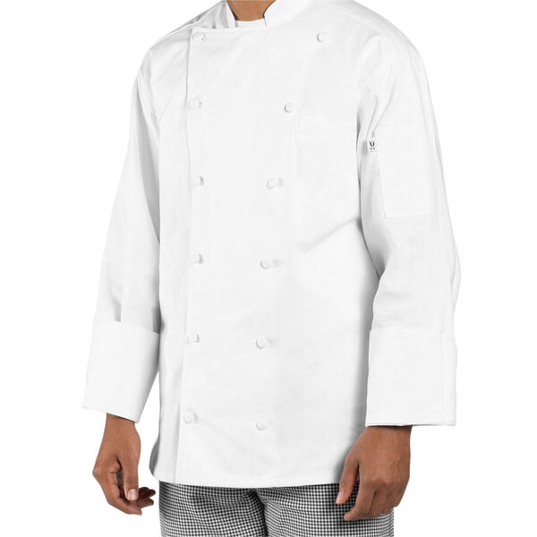 A person wearing a white Uncommon Chef long sleeve chef coat.