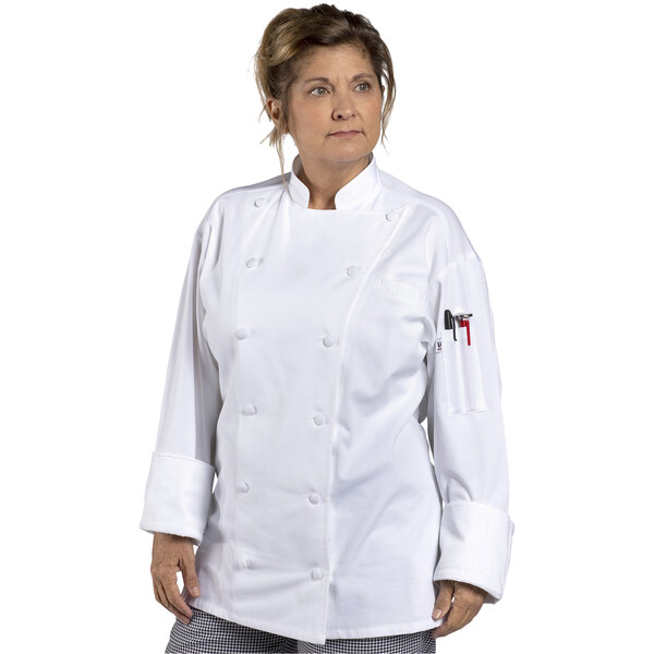 A woman wearing a white Uncommon Chef long sleeve chef coat with mesh back.