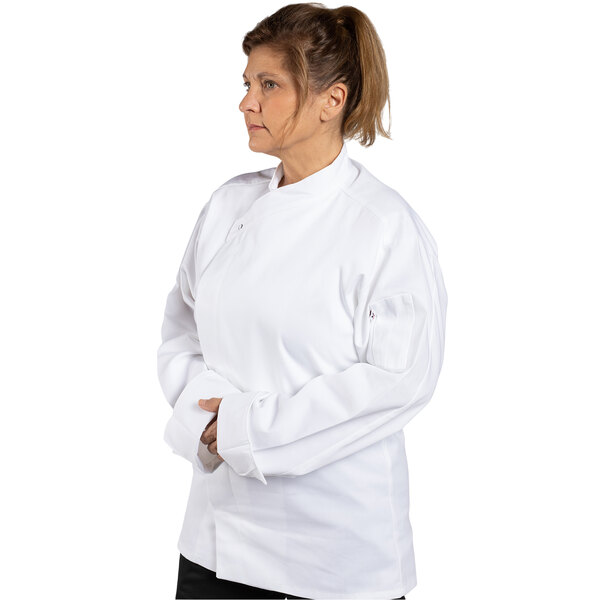 A woman wearing a white Uncommon Chef long sleeve chef coat.