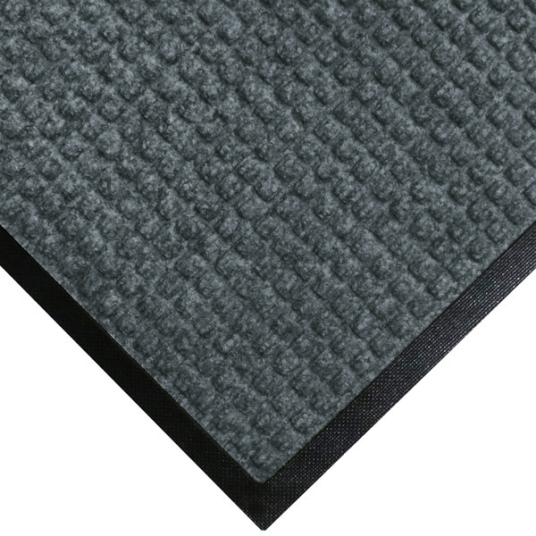 A grey WaterHog carpet mat with black rubber border.