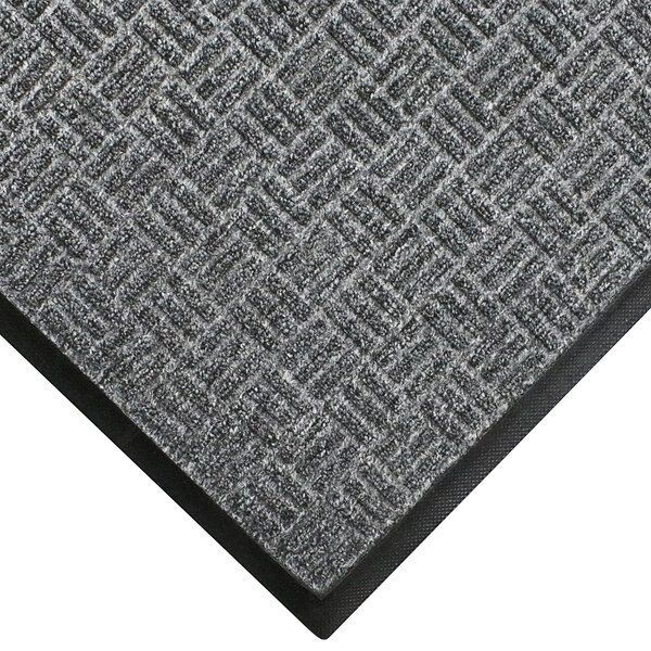 A close-up of a grey WaterHog doormat with a black border.