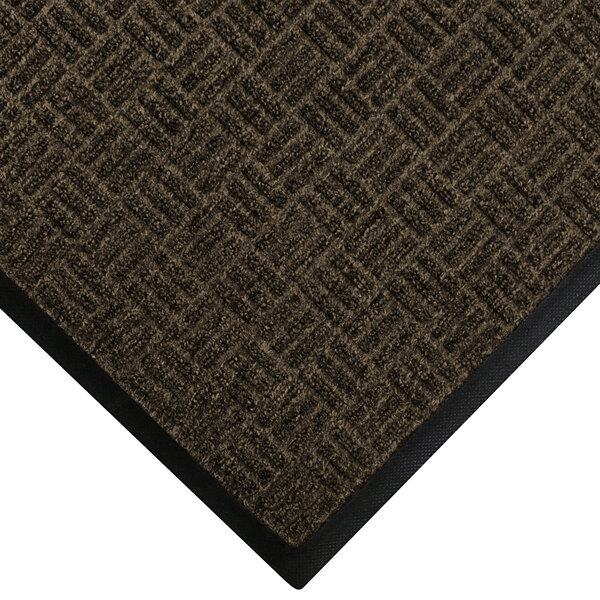 A brown WaterHog doormat with black trim.