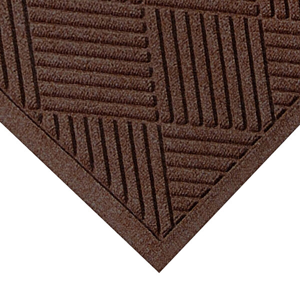 A close-up of a dark brown WaterHog Diamond Fashion mat with a fabric border.