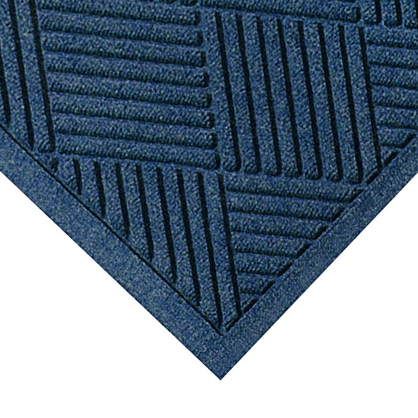 A close-up of a M+A Matting navy blue mat with a square pattern.
