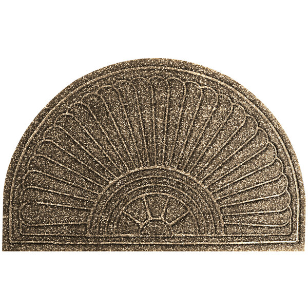 A close-up of a khaki half oval doormat with a sun design.