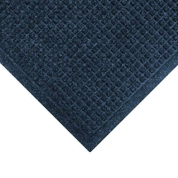 A close-up of a navy WaterHog mat with a diamond patterned border.
