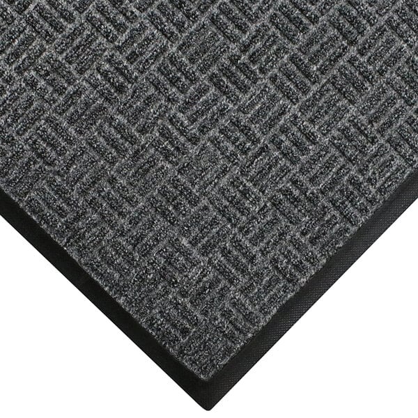 A close-up of a gray WaterHog Masterpiece carpet with black trim.