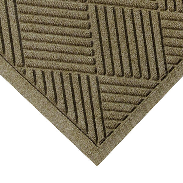 A close-up of a brown M+A Matting WaterHog mat with a diamond pattern.