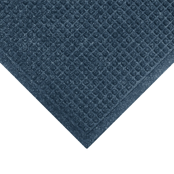 A blue WaterHog mat with a diamond patterned border.
